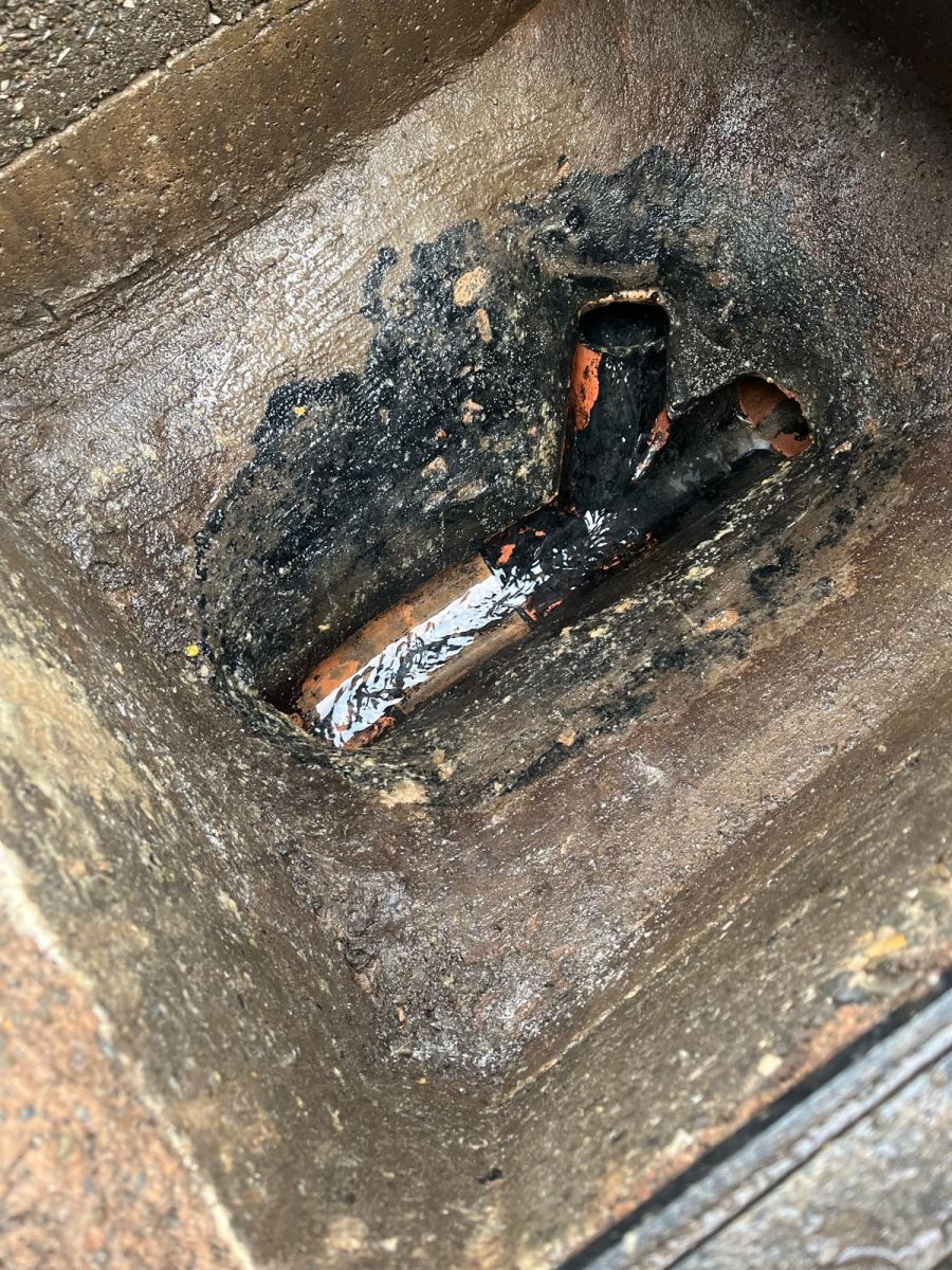 Same chamber after jetting, with clay pipe channels clear and water flowing